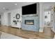 Living room featuring a fireplace with a gray brick surround, flat screen television, and decorative accents at 4040 Eaton Park St, Aurora, CO 80019