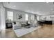 Bright, open-concept living space with hardwood floors, comfortable seating, and an open kitchen at 4040 Eaton Park St, Aurora, CO 80019