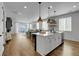 Open-concept living space featuring hardwood floors, an island kitchen, and lots of natural light at 4040 Eaton Park St, Aurora, CO 80019