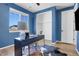 Home office with a blue wall, natural light, and a spacious closet for storage; comfortable workspace at 4040 Eaton Park St, Aurora, CO 80019