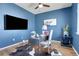 Stylish home office with blue walls, wooden floors, and a modern desk setup; perfect for remote work at 4040 Eaton Park St, Aurora, CO 80019