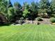 Serene backyard featuring a stone patio, outdoor seating, and tiered landscaping at 3188 Lynwood Ave, Highlands Ranch, CO 80126