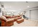 Spacious finished basement with leather furniture, bar area and gaming area at 3188 Lynwood Ave, Highlands Ranch, CO 80126