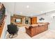 Basement living area with a stone accent wall, fireplace, tv and wood shelving at 3188 Lynwood Ave, Highlands Ranch, CO 80126