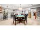 Finished basement with a game table, bar area, and staircase at 3188 Lynwood Ave, Highlands Ranch, CO 80126