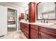 Bathroom featuring double vanity with granite counters and cherry cabinetry at 3188 Lynwood Ave, Highlands Ranch, CO 80126