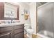 Bathroom featuring a vanity, framed mirror, and a glass-enclosed shower at 3188 Lynwood Ave, Highlands Ranch, CO 80126