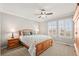 Comfortable bedroom features a ceiling fan, natural light, and window shutters at 3188 Lynwood Ave, Highlands Ranch, CO 80126