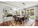 Open dining area with hardwood floors leading to a spacious living room and outdoor views at 3188 Lynwood Ave, Highlands Ranch, CO 80126