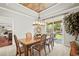 Bright dining room featuring a stylish light fixture, a wooden table with seating, and a sliding door to the backyard at 3188 Lynwood Ave, Highlands Ranch, CO 80126