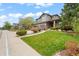 Charming two-story home with a well-manicured lawn, beautiful landscaping, and a driveway leading to the two-car garage at 3188 Lynwood Ave, Highlands Ranch, CO 80126