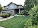 Beautifully landscaped front yard leading to a well-maintained, two-story home with an attached two-car garage at 3188 Lynwood Ave, Highlands Ranch, CO 80126
