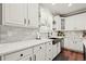 Bright kitchen featuring white cabinets, stylish countertops, and a sleek black faucet at 3188 Lynwood Ave, Highlands Ranch, CO 80126