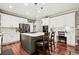 Well-designed kitchen features an island with seating, sleek countertops, and stainless steel appliances at 3188 Lynwood Ave, Highlands Ranch, CO 80126