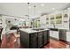 Bright open-concept kitchen boasts modern island with gas cooktop and hardwood floors at 3188 Lynwood Ave, Highlands Ranch, CO 80126