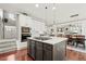Spacious kitchen features modern island with gas cooktop, stainless appliances, and hardwood floors at 3188 Lynwood Ave, Highlands Ranch, CO 80126