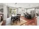 Bright kitchen connects to dining area, featuring white cabinets, modern finishes, and ample sunlight at 3188 Lynwood Ave, Highlands Ranch, CO 80126