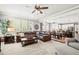 Expansive living room with large windows, comfortable seating, and seamless flow to the kitchen and dining area at 3188 Lynwood Ave, Highlands Ranch, CO 80126