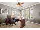 Bright office featuring neutral tones, a ceiling fan, three windows with shutter blinds, and a spacious dark wood desk at 3188 Lynwood Ave, Highlands Ranch, CO 80126