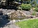 Charming backyard waterfall feature creating a relaxing and serene environment at 3188 Lynwood Ave, Highlands Ranch, CO 80126