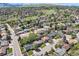 Wide aerial shot of a suburban neighborhood with lush greenery, mature trees, and scenic mountain views at 1977 S Urban St, Lakewood, CO 80228