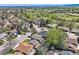 Picturesque aerial view showcasing the neighborhood's serene setting with lush greenery and mountain views at 1977 S Urban St, Lakewood, CO 80228