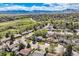 Picturesque aerial view of a residential neighborhood, showcasing mature trees, manicured lawns, and mountain views at 1977 S Urban St, Lakewood, CO 80228