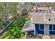View of backyard featuring a covered patio, green lawn, and wood fence providing a private outdoor space at 1977 S Urban St, Lakewood, CO 80228