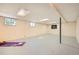 Large, unfinished basement area with a workout mat, windows, and neutral paint, perfect for storage or recreation at 1977 S Urban St, Lakewood, CO 80228