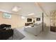 Finished basement with white walls, tile flooring, and a large entertainment center at 1977 S Urban St, Lakewood, CO 80228