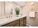 Updated bathroom featuring dual sinks, wood cabinets, modern fixtures, and neutral decor at 1977 S Urban St, Lakewood, CO 80228