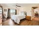 Bedroom with hardwood floors, ceiling fan, and a view of mountains from the window at 1977 S Urban St, Lakewood, CO 80228