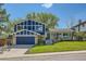 Inviting two-story home with manicured lawn, blue siding, and a welcoming front entrance at 1977 S Urban St, Lakewood, CO 80228