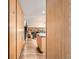 Hallway with hardwood floors, leading to an open-concept living space and staircase at 1977 S Urban St, Lakewood, CO 80228