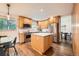 Bright kitchen with island, stainless steel appliances, and hardwood floors adjoining breakfast nook at 1977 S Urban St, Lakewood, CO 80228