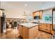 Modern kitchen featuring an island, stainless steel appliances, and open layout to the living space at 1977 S Urban St, Lakewood, CO 80228