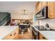 Well-lit kitchen overlooking a dining area and living space, featuring stainless appliances and hardwood floors at 1977 S Urban St, Lakewood, CO 80228
