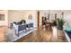 Open living space with hardwood floors, stylish decor, and seamless flow to dining area at 1977 S Urban St, Lakewood, CO 80228