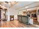 Spacious living room with brick fireplace, beamed ceiling, and hardwood floors at 1977 S Urban St, Lakewood, CO 80228