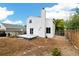 Backyard featuring an open backyard with wooden fence, a white house, and a gray deck at 11376 Forest Dr, Thornton, CO 80233