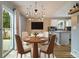 Dining area featuring a modern chandelier, hardwood floors, and a view into the kitchen and access to the backyard at 11376 Forest Dr, Thornton, CO 80233