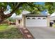 Charming two-story home with a well-maintained lawn, mature tree, and a two-car garage with decorative windows at 11376 Forest Dr, Thornton, CO 80233