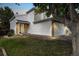 Home exterior with a two-car garage, nice landscaping, and a mature shade tree at 11376 Forest Dr, Thornton, CO 80233