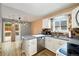 Bright eat-in kitchen with stainless steel appliances, light countertops and wood backsplash at 11376 Forest Dr, Thornton, CO 80233