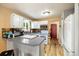Functional kitchen featuring white cabinets, gray countertops, modern appliances, and hardwood flooring at 11376 Forest Dr, Thornton, CO 80233