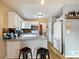 Bright kitchen with modern lighting, hardwood floors, white cabinets, and updated appliances at 11376 Forest Dr, Thornton, CO 80233