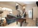 Inviting living room with open staircase, modern lighting, hardwood floors, and a comfortable sofa at 11376 Forest Dr, Thornton, CO 80233