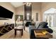 Bright living room featuring vaulted ceilings, a modern fireplace, hardwood floors and a large window with green curtains at 11376 Forest Dr, Thornton, CO 80233