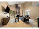 Comfortable living room boasts vaulted ceilings, stylish decor, hardwood floors, and a cozy fireplace at 11376 Forest Dr, Thornton, CO 80233