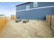 Backyard with a dirt area with planters next to house at 562 Twilight Ct, Fort Lupton, CO 80621